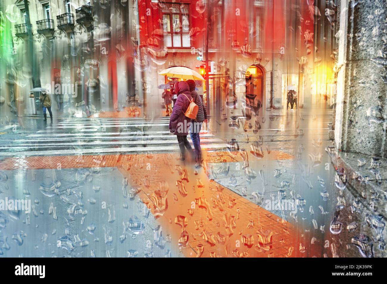 people with an umbrella on the street in rainy days, autumn season ...