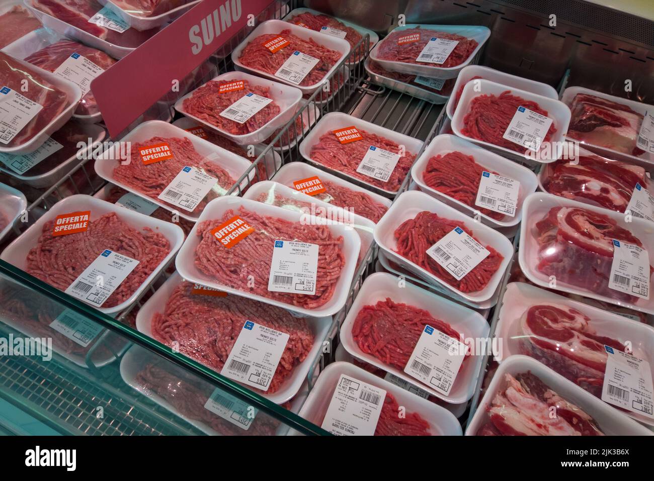 Fossano, Italy - July 29, 2022: Raw minced meat in plastic food trays in the refrigerated counter of the Italian supermarket Eurospin. Stock Photo