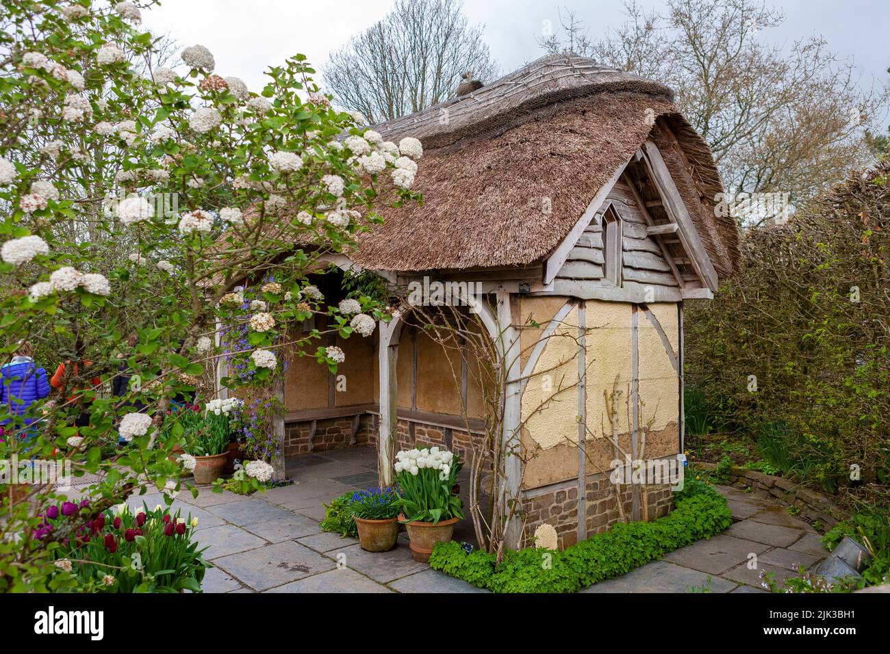 The charming thatched Summer house in The Potager and Cottage Garden, RHS Rosemoor, Devon, UK Stock Photo