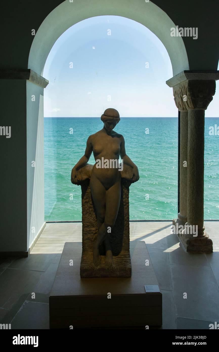 Hall with statues and a large window to the sea in the Marisel Museum, Sitges, Spain Stock Photo
