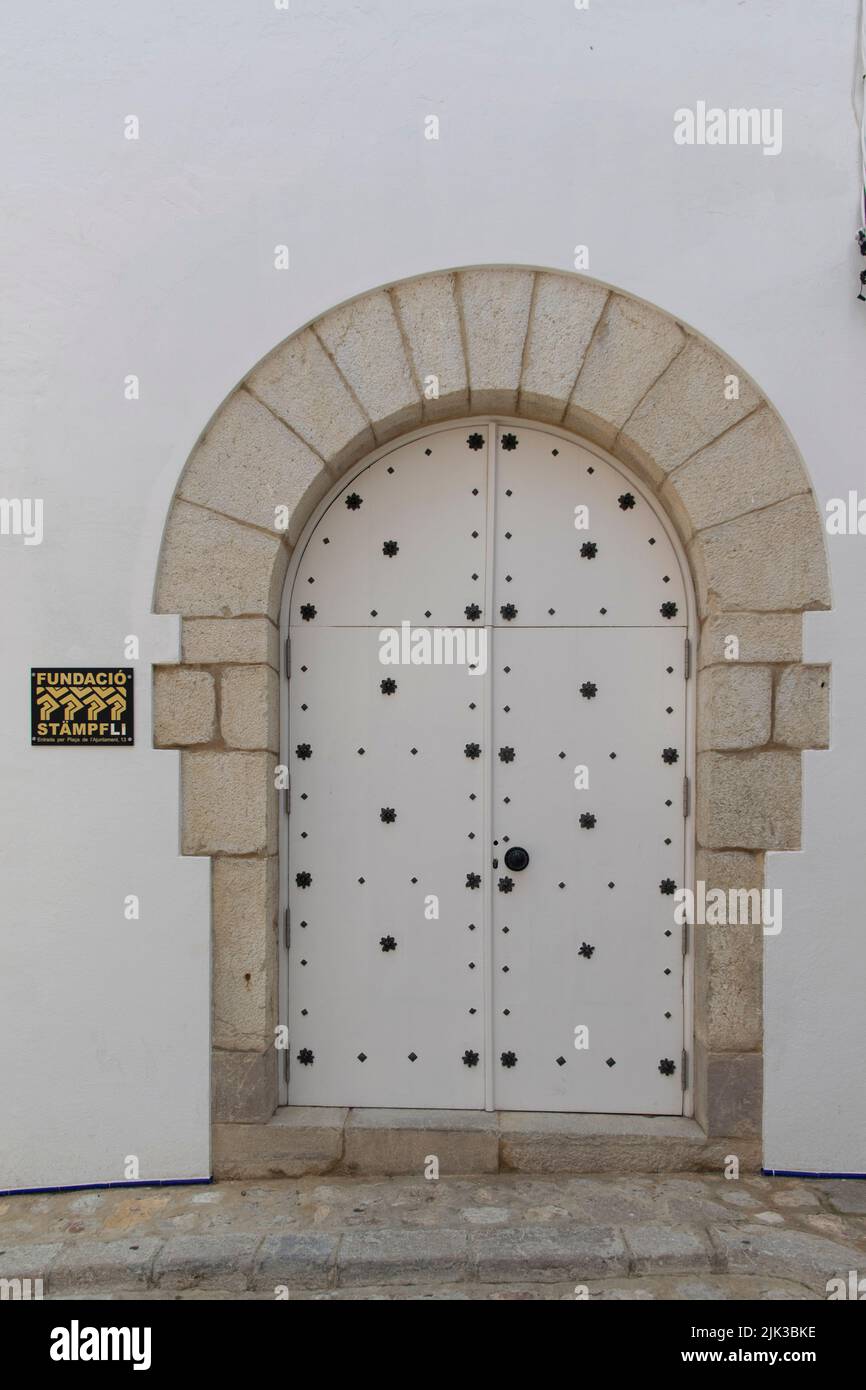An old whote door at Carrer d'en Bosc, Sitges, Barcelona Province Stock Photo