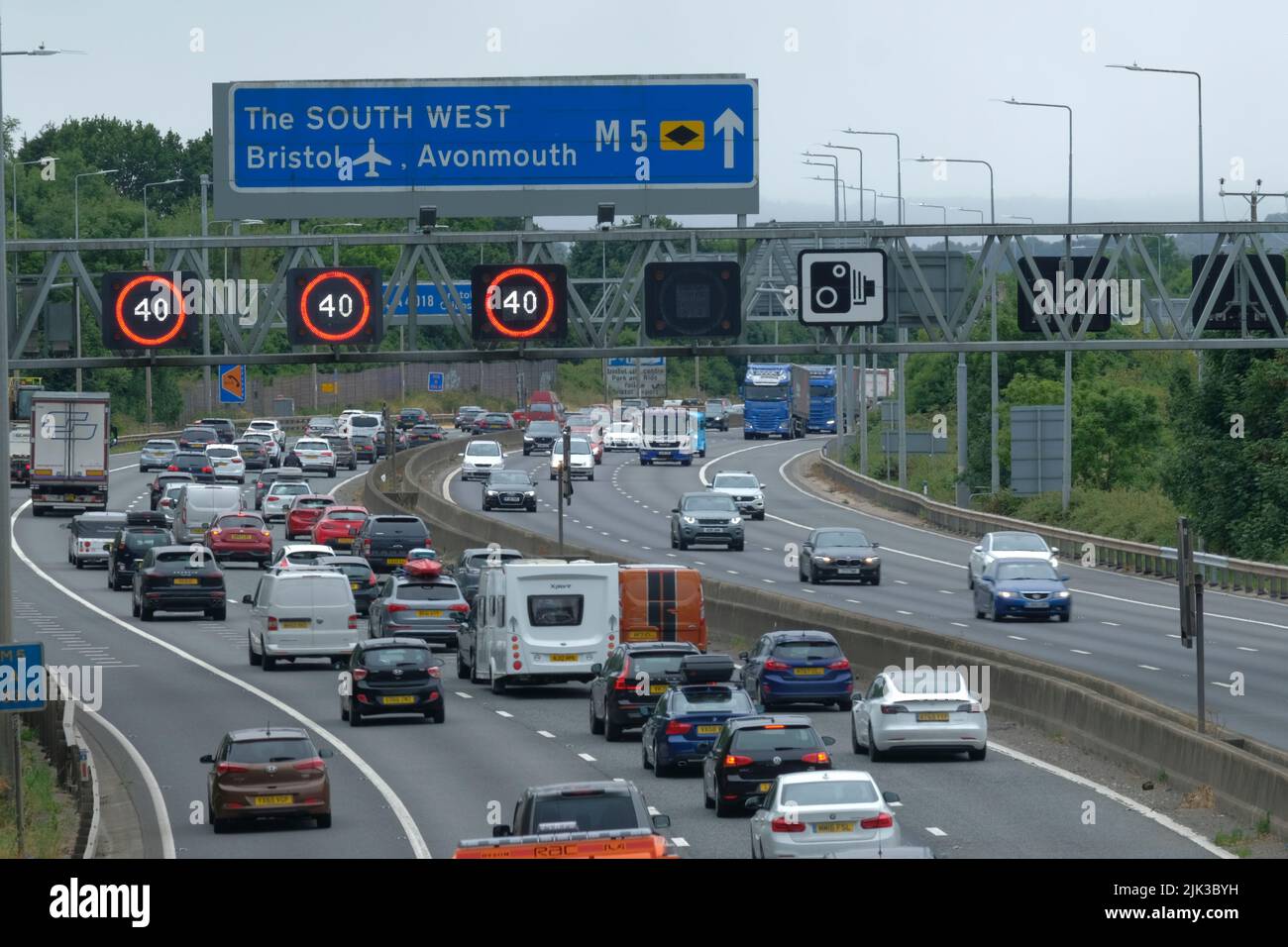 Bristol, UK. 30th July, 2022. Train strike puts additional pressure on the motorways today, the AA have issued an Amber Alert and advise driving will be difficult; drivers should prepare well and take extra care. Picture shows heavy congestion on the M5 near J15 as people head south. Managed Motorway matrix's are on. Highways England show average speeds below 30MPH. Credit: JMF News/Alamy Live News Stock Photo