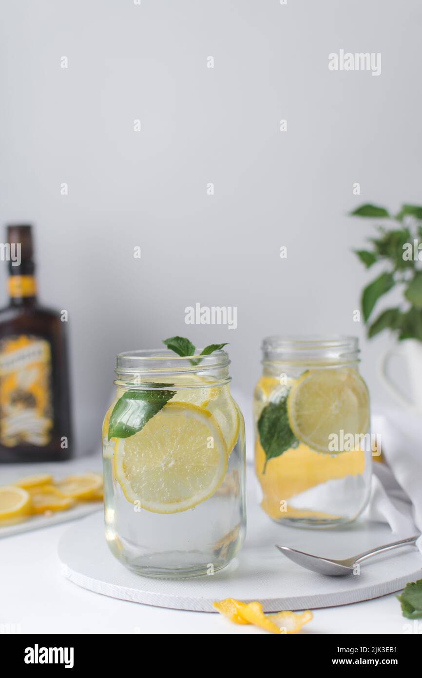 Lemon lime soda in a mason jar with a lemon slice and basil leaves, lemonade in a glass jar Stock Photo