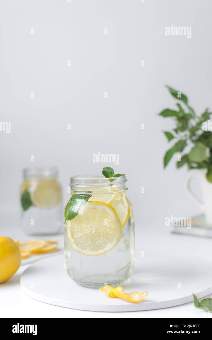 Lemon lime soda in a mason jar with a lemon slice and basil leaves, lemonade in a glass jar Stock Photo
