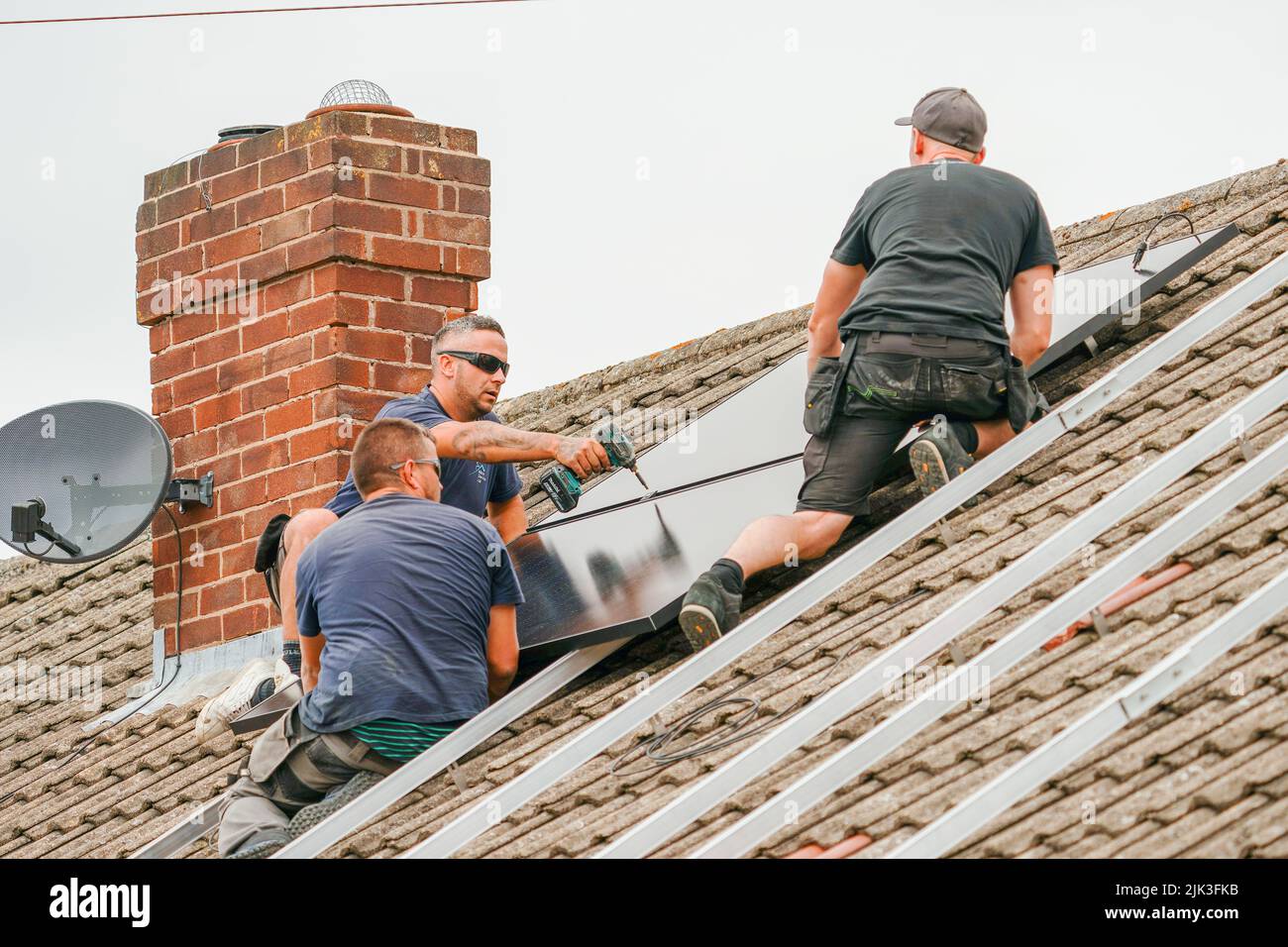 Electrician installing solar panels Stock Photo