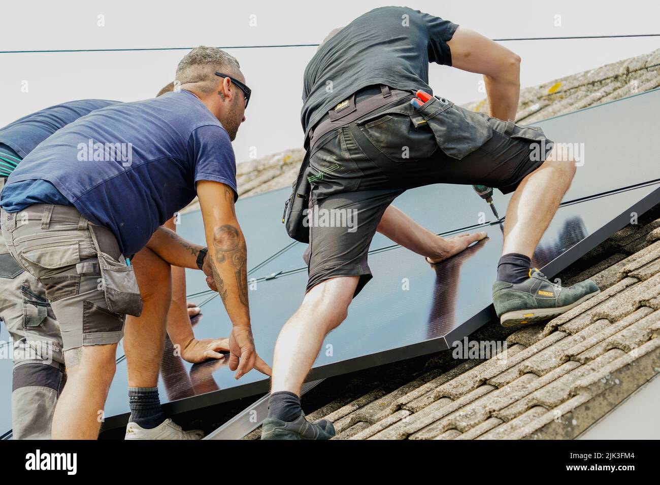 Electrician installing solar panels Stock Photo