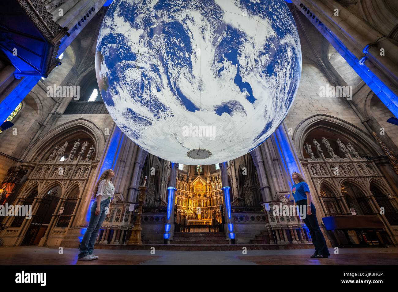 London, UK. 30th July, 2022. Gaia earth installation by Luke Jerram in St John the Baptist Church, Shepherd's Bush. The monumental internally-lit sculpture returns to the city as part of Kensington + Chelsea Festival. UK artist Jerram aims to instil a sense of ‘overview effect’ that astronauts experience when looking down at earth from space. Credit: Guy Corbishley/Alamy Live News Stock Photo