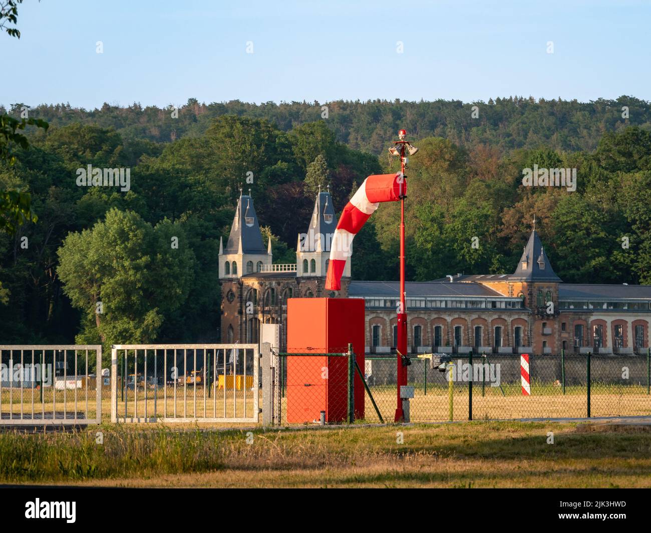 Windsock hanging on a pole. Equipment for measuring the wind speed and direction. Measurement station to monitor the weather (meteorology). Stock Photo
