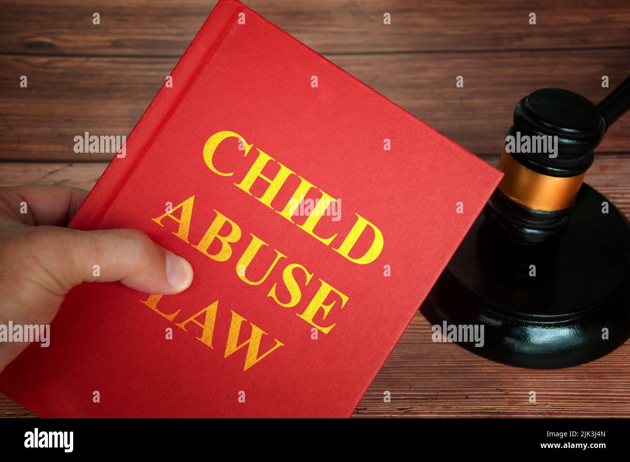 Child abuse law text on law book with judge gavel on wooden desk background. Law concept Stock Photo