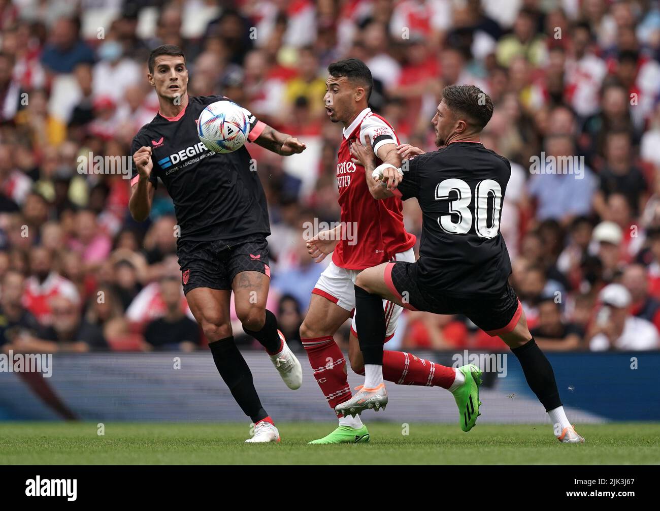 Arsenal's Gabriel Martinelli (centre) in action with Sevilla's Jose Angel Carmona (right) and Erik Lamela during the Emirates Cup final at the Emirates Stadium, London. Picture date: Saturday July 30, 2022. Stock Photo