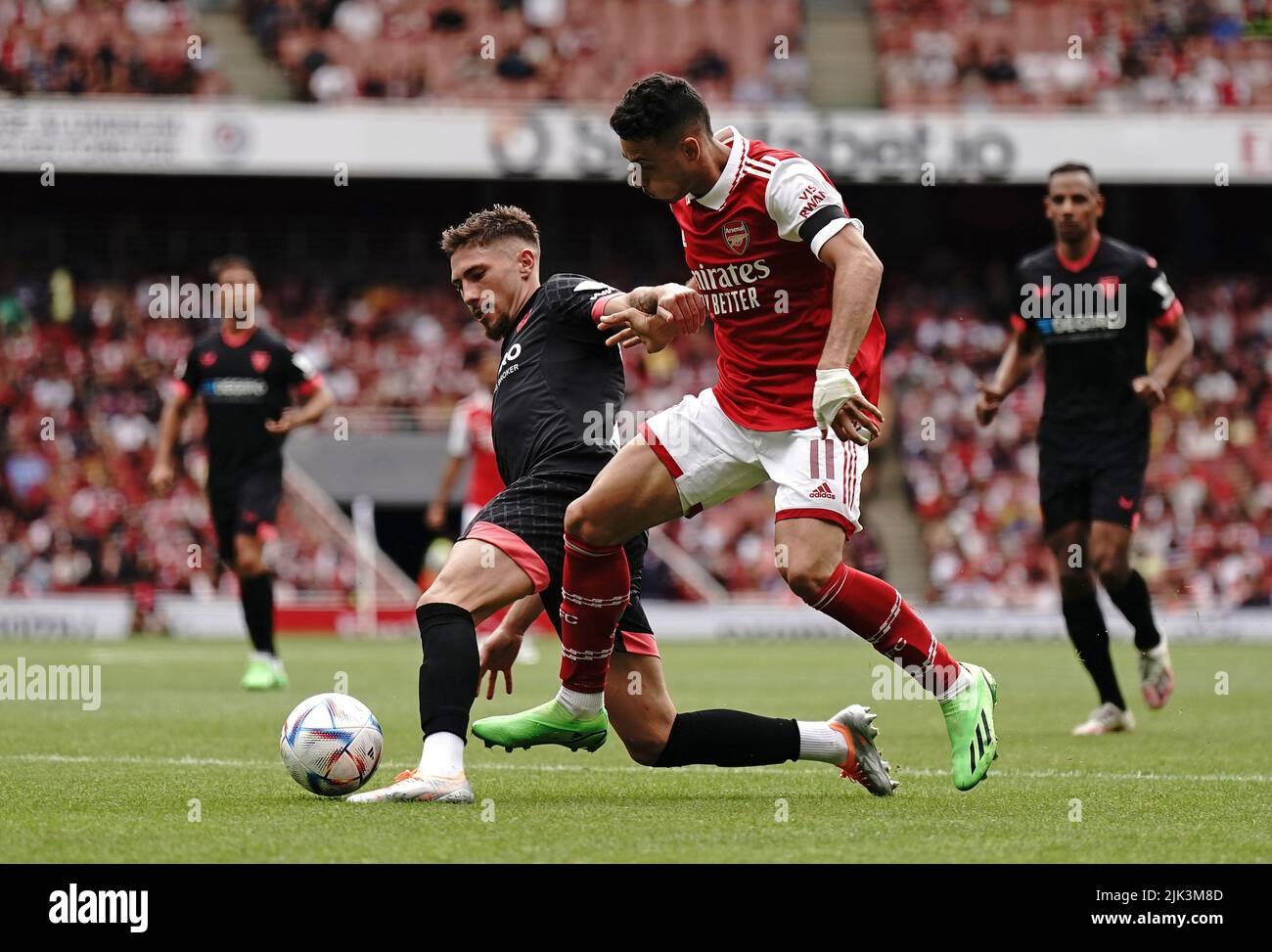 Sevilla's Jose Angel Carmona (left) and Arsenal's Gabriel Martinelli battle for the ball during the Emirates Cup final at the Emirates Stadium, London. Picture date: Saturday July 30, 2022. Stock Photo