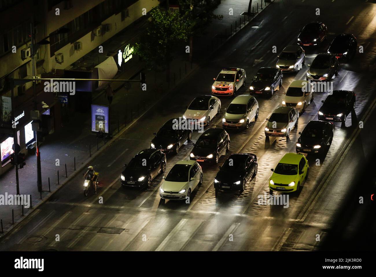 Bucharest, Romania - July 30, 2022: Cars wait at a red traffic light at night on Magheru boulevard in Bucharest. Stock Photo