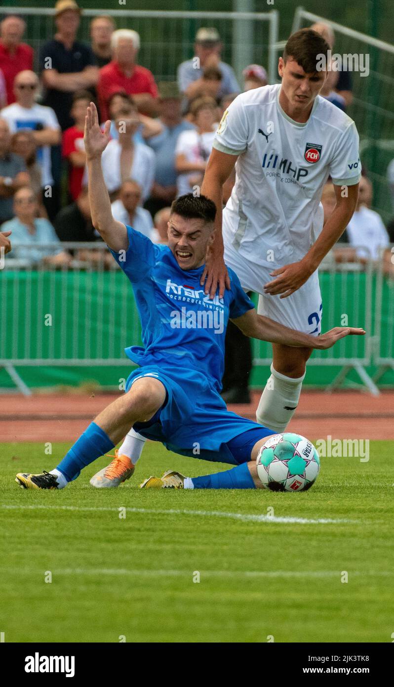 Illertissen, Germany. 30th July, 2022. Soccer: DFB Cup, FV Illertissen - 1. FC Heidenheim, 1st round, Vöhlin Stadium. Illertissen's Maurice Strobel (l) and Heidenheim's Thomas Keller fight for the ball. Credit: Stefan Puchner/dpa - IMPORTANT NOTE: In accordance with the requirements of the DFL Deutsche Fußball Liga and the DFB Deutscher Fußball-Bund, it is prohibited to use or have used photographs taken in the stadium and/or of the match in the form of sequence pictures and/or video-like photo series./dpa/Alamy Live News Stock Photo
