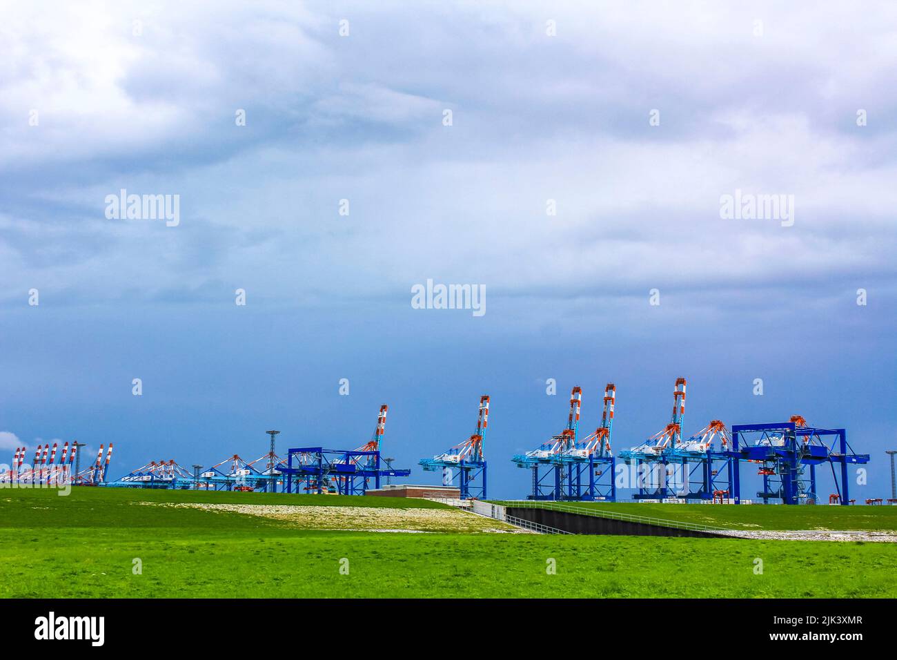Industrial area cranes and red tower lighthouse with beautiful
