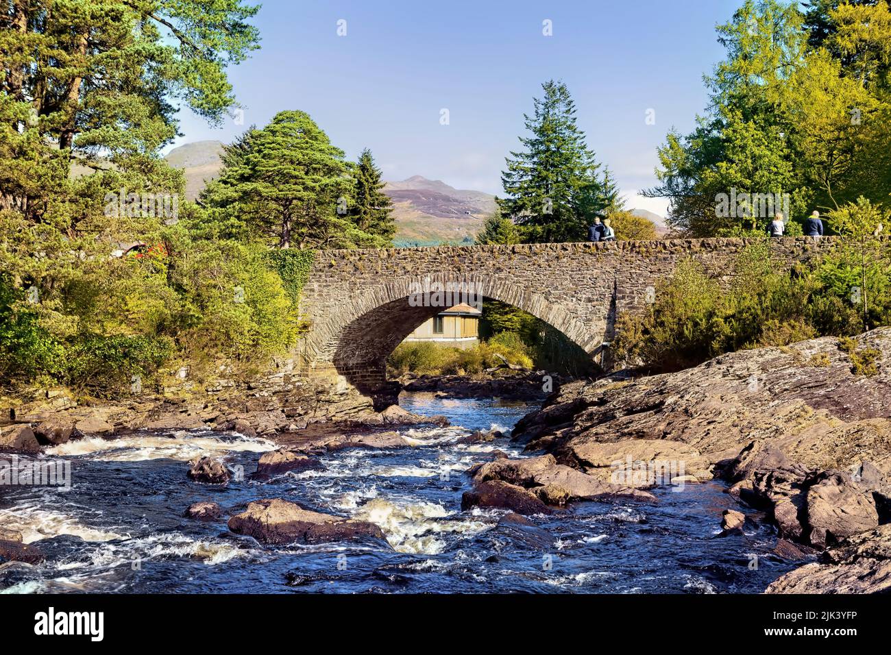 The bridge at the village of Killin in Stirlingshire, Scotland that crosses the Falls of Dochart. A popular place for visitors to stop off on their jo Stock Photo