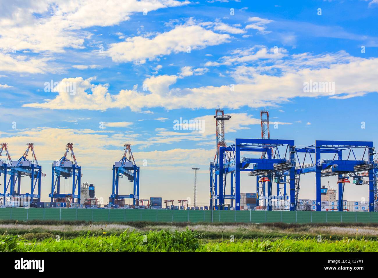Industrial area cranes and red tower lighthouse with beautiful