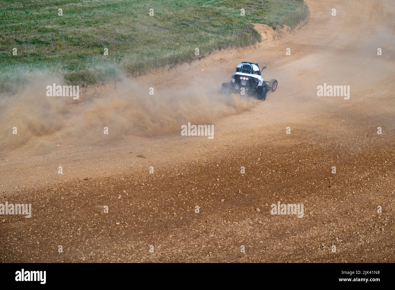 buggies on the autocross track, skidding, dust and dirt flying under ...