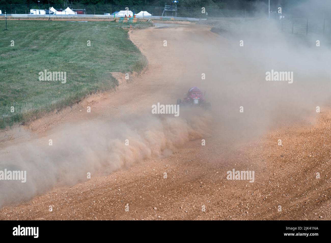 buggies on the autocross track, skidding, dust and dirt flying under ...