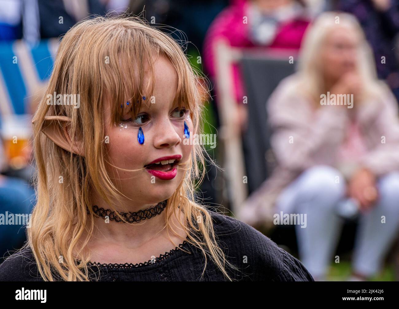 Harrogate, 30th July 2022. The Harrogate Carnival is taking place today under gloomy skies. A young girl is made up for the occasion. Picture Credit: ernesto rogata/Alamy Live News Stock Photo
