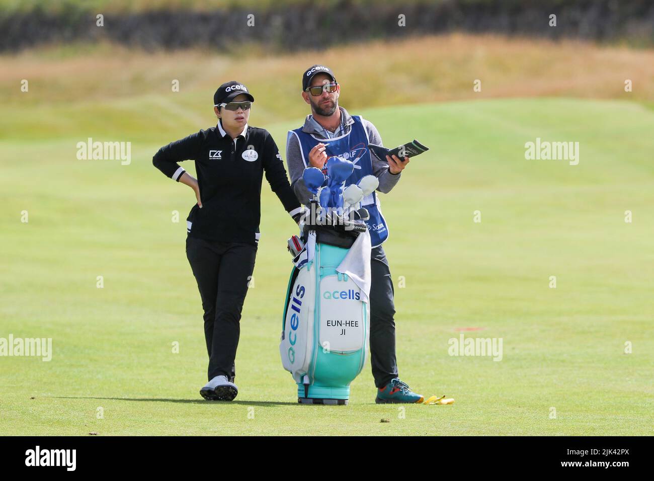 Irvine, UK. 30th July, 2022. The third round of the Trust Golf Women's Scottish Golf took place with 75 players making the cut. Heavy overnight rain from Friday into Saturday made for a softer and more testing course. Eun-Hee ji with her caddie on the 12th fairway. Credit: Findlay/Alamy Live News Stock Photo