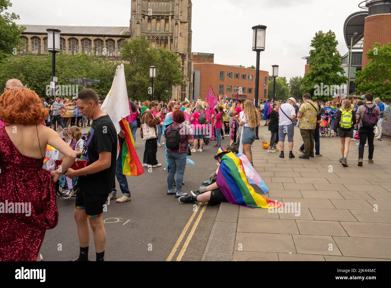 people waiting on kerbside waiting for LGBT Pride march to go ahead Stock Photo