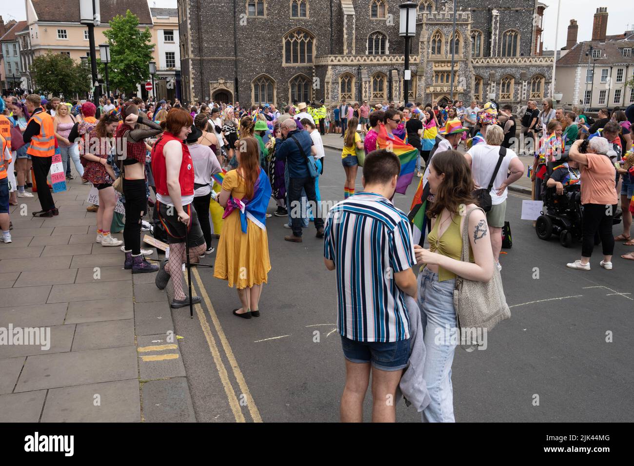 people waiting on kerbside waiting for LGBT Pride march to go ahead Stock Photo