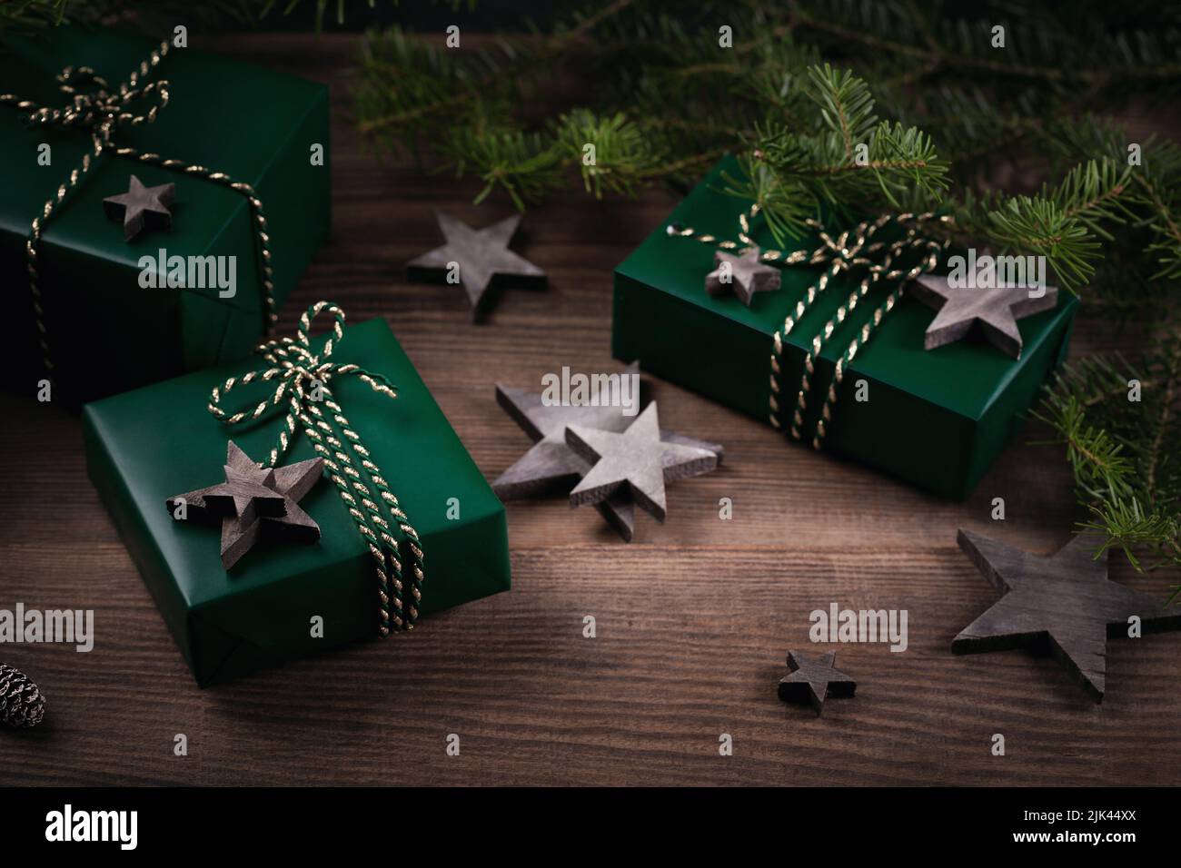 Christmas frame with green gift boxes, star decorations and spruce ...