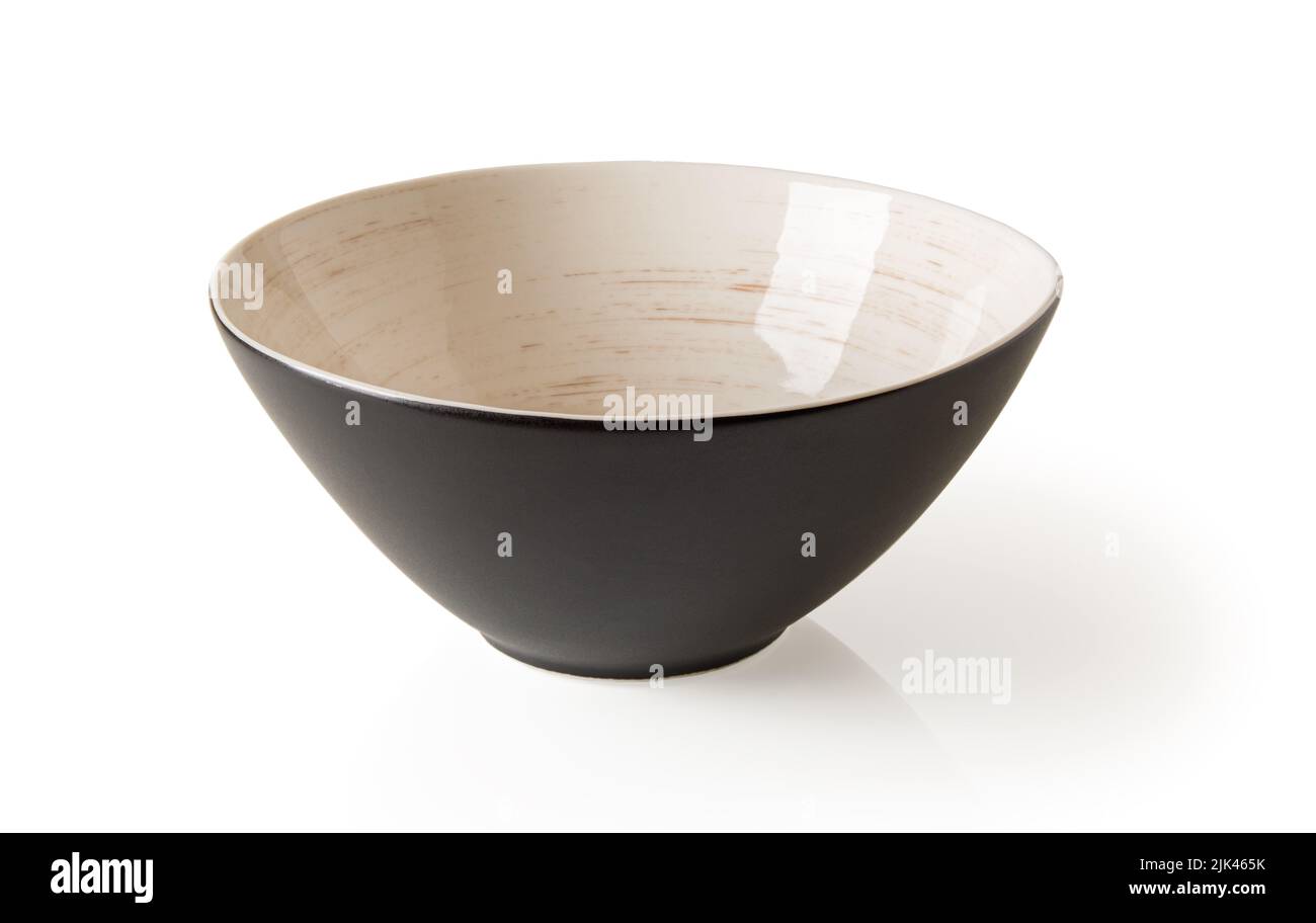 Porcelain bowl isolated on a white background. Black ramekin decorated inside with brown circular lines over beige background. Modern tableware cutout Stock Photo