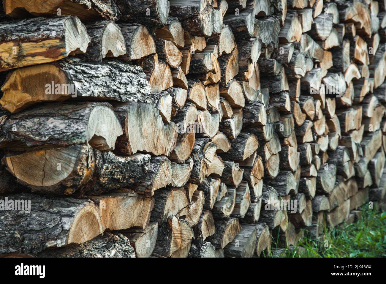 Woodpile. Textured firewood background. Pile of old dry chopped fire wood Stock Photo