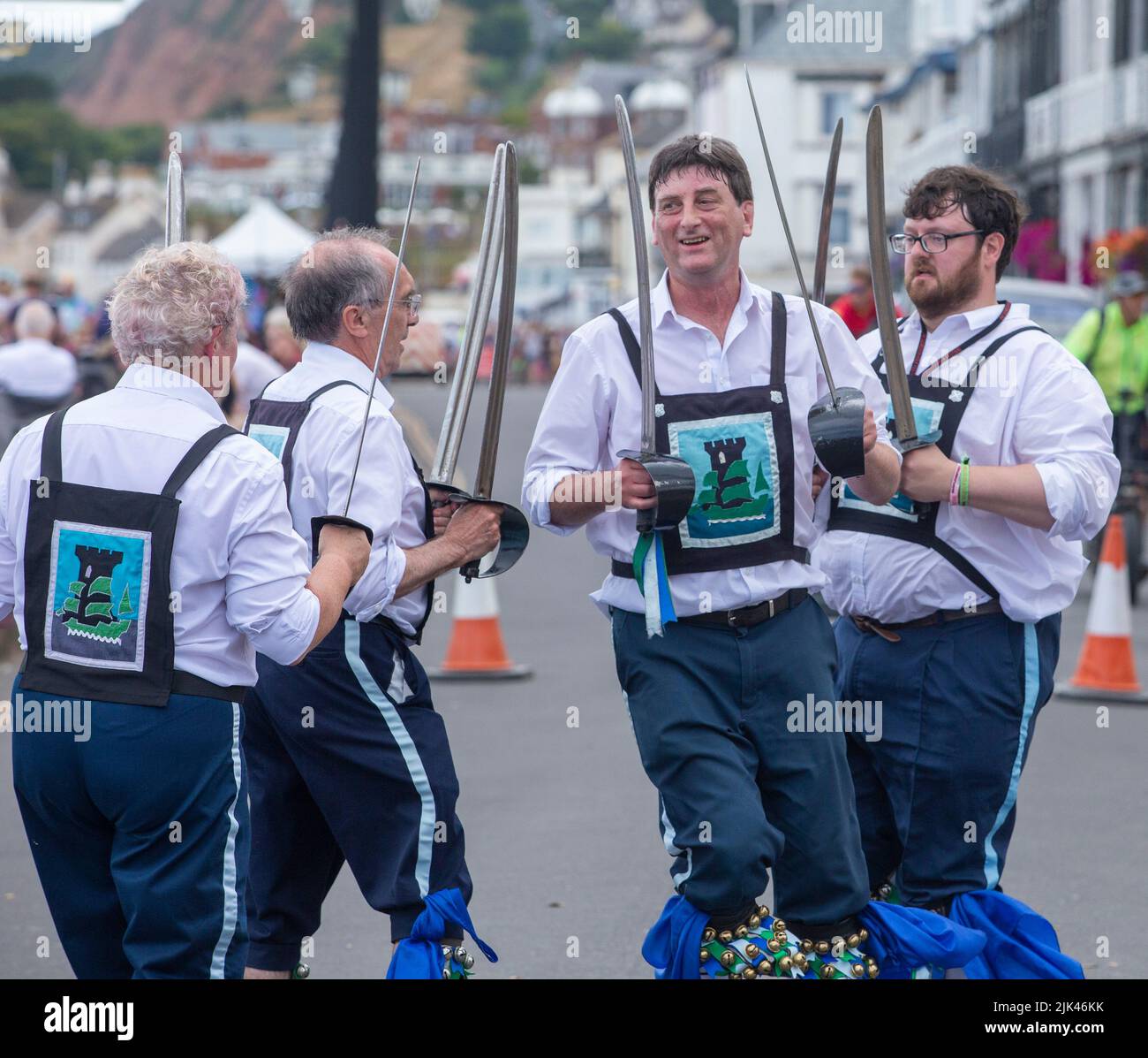 Sidmouth, 30th July 2022 Sabre Dance - Morris dancers clash swords on Sidmouth Esplanade as Folk Week gets under way. Tony Charnock/Alamy Live News Stock Photo