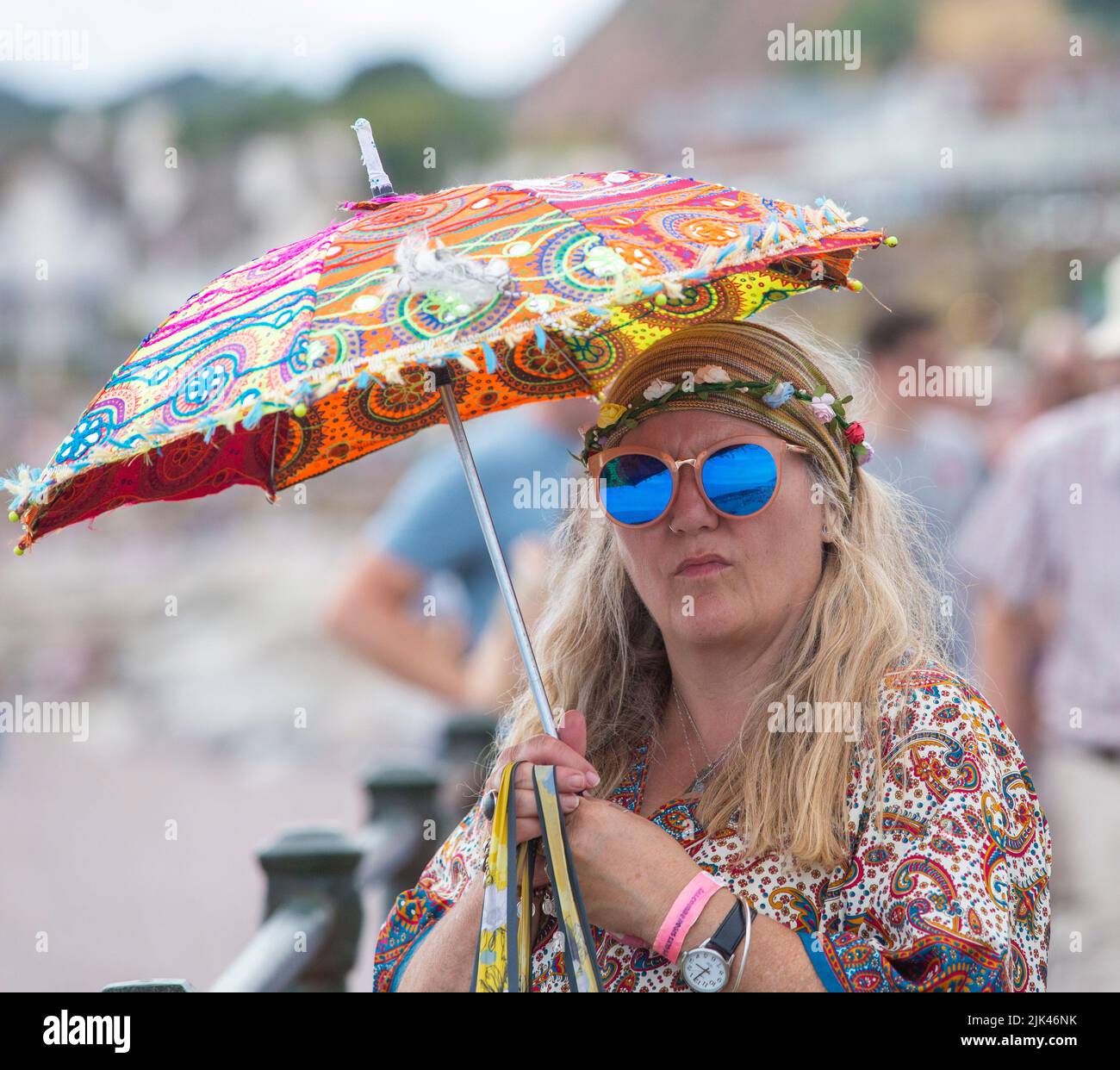 Sidmouth, 30th July 2022 Sidmouth Folk Week Festival - people along the Esplanade Tony Charnock/Alamy Live News Stock Photo