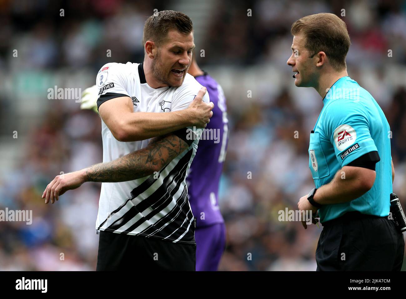 Derby County's James Collins (left) speaks to referee Anthony Backhouse during the Sky Bet League One match at Pride Park Stadium, Derby. Picture date: Saturday July 30, 2022. Stock Photo