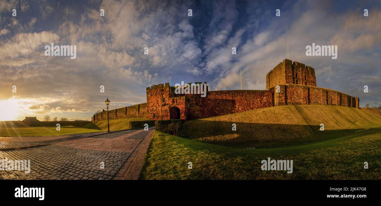 A panoramic view of Carlisle Castle with De Ireby's Tower, The Keep and Bridge over Outer Moat at sunset. Stock Photo