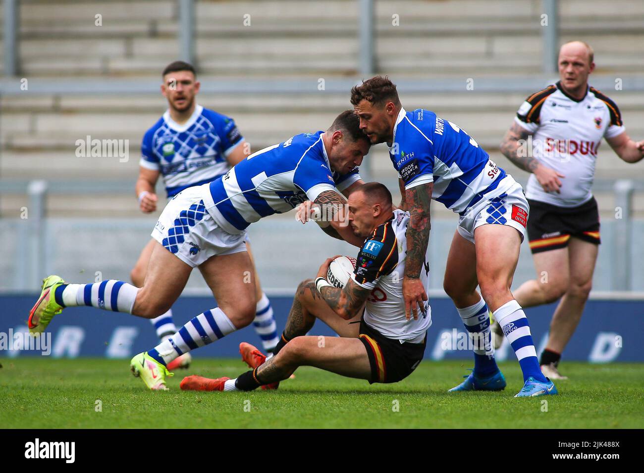 Leeds, UK. 30th July, 2022. *** Ben Kavanagh and Greg Worthington of Halifax stop Dec Patton of Bradford during the Summer Bash Betfred Championship match between Bradford Bulls and Halifax Panthers at Headingley Stadium, Leeds, UK on 30 July 2022. Photo by Simon Hall. Editorial use only, license required for commercial use. No use in betting, games or a single club/league/player publications. Credit: UK Sports Pics Ltd/Alamy Live News Stock Photo