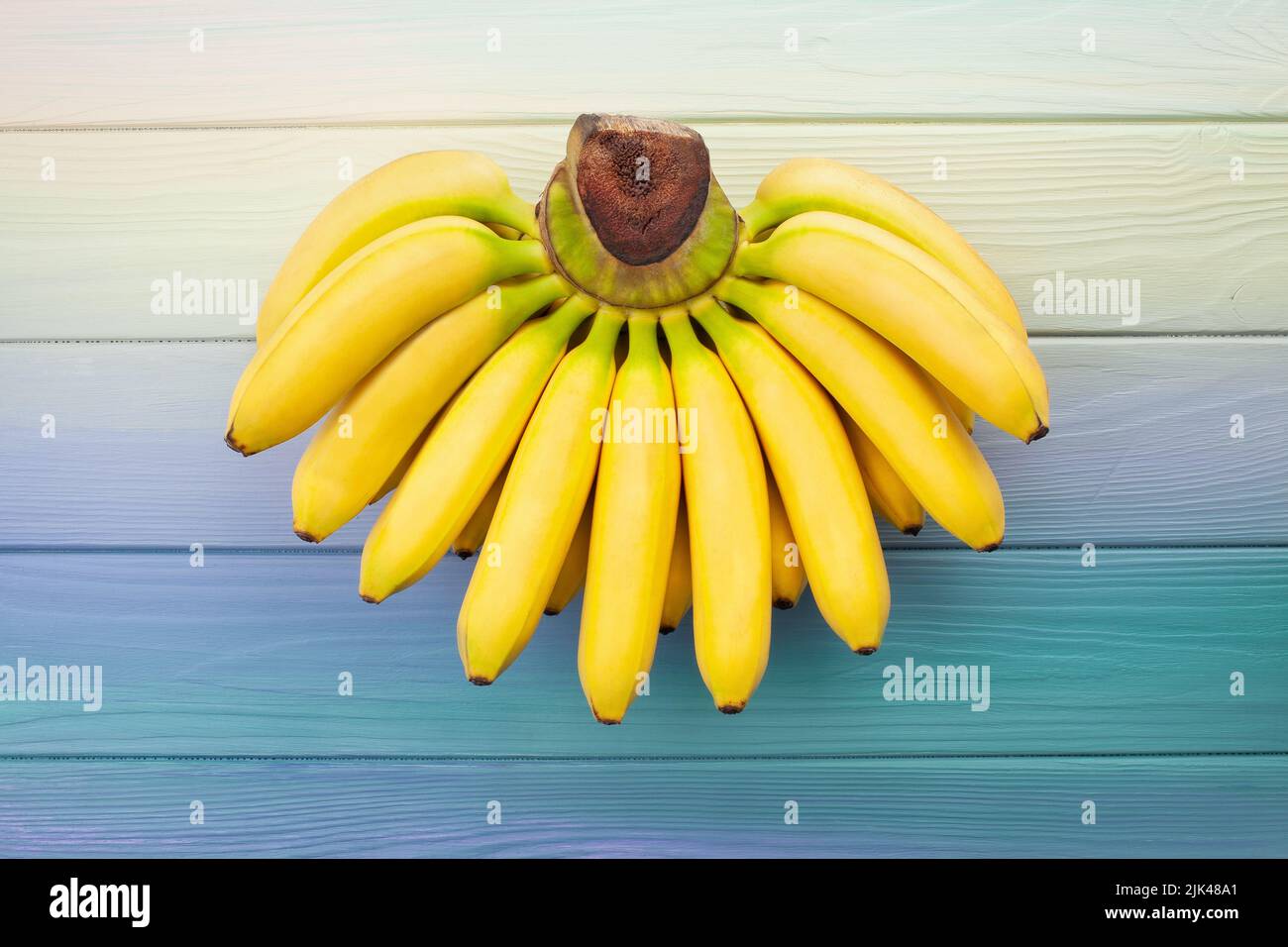 baby banana on wood background Stock Photo