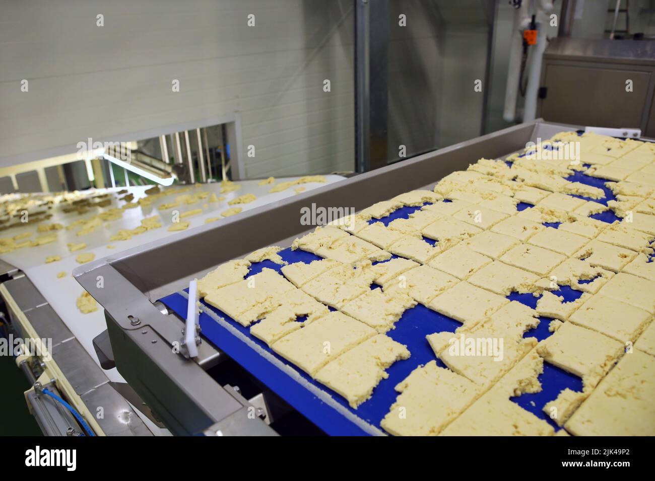 Dough cutting line for biscuits. The latest biscuit production line. Large biscuit factory Stock Photo