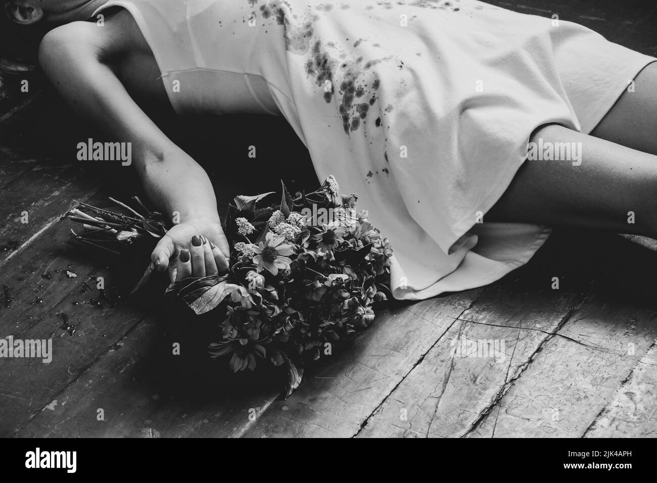 A girl in a bloody white dress lies on the floor of the house and next to a bouquet of flowers, the war in Ukraine, a girl killed by a Russian soldier Stock Photo