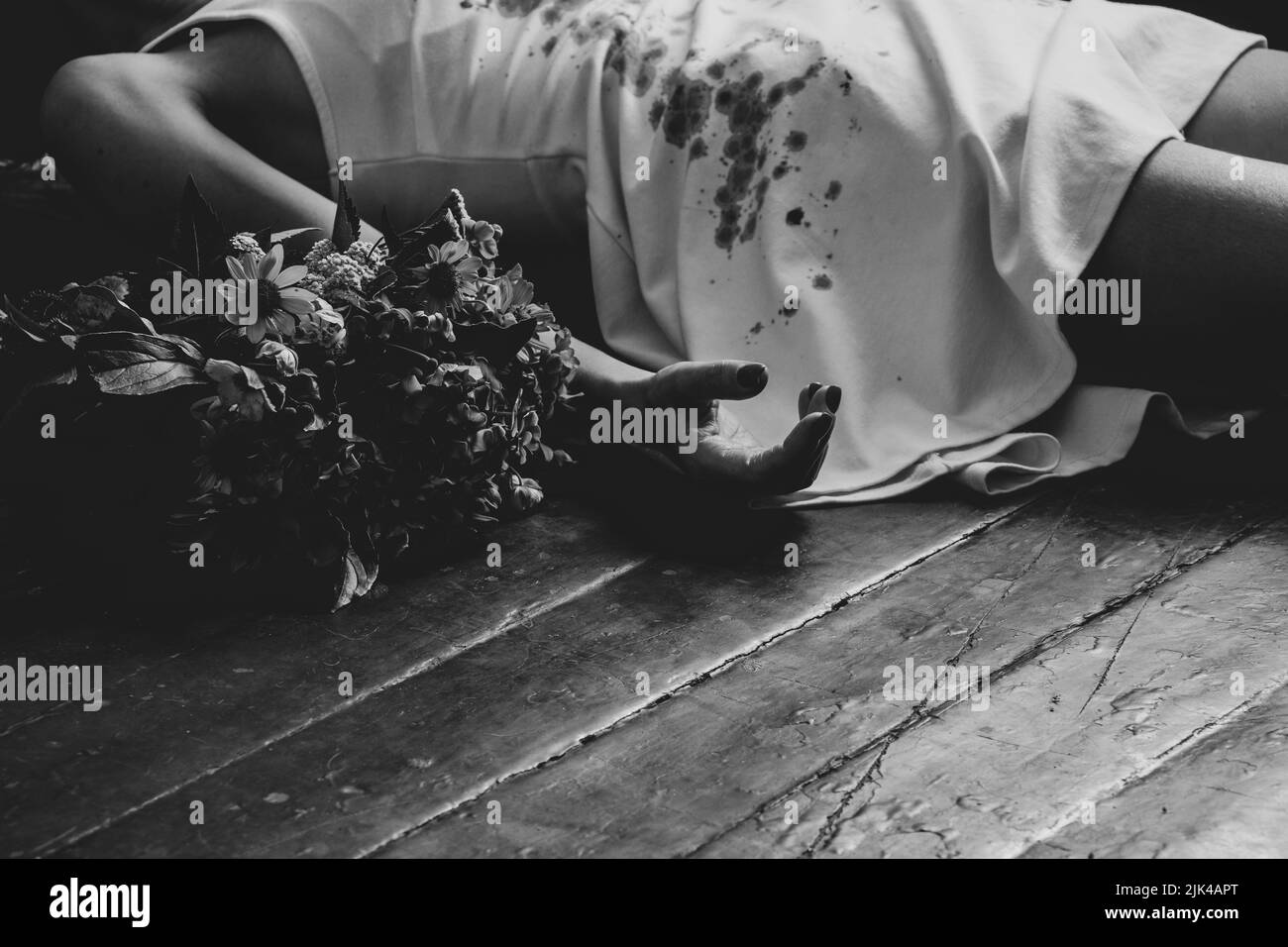 A girl in a bloody white dress lies on the floor of the house and next to a bouquet of flowers, the war in Ukraine, a girl killed by a Russian soldier Stock Photo