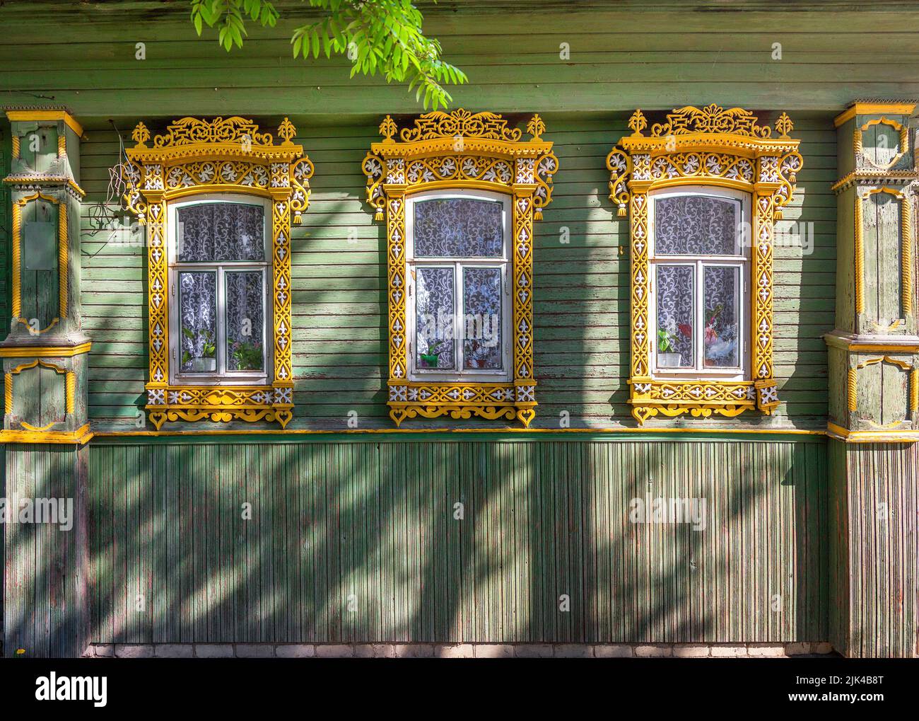 The beautiful old windows with beautifully designed platbands window on an old wooden house in Semenov city. Nizhny Novgorod Region, Russia. Stock Photo