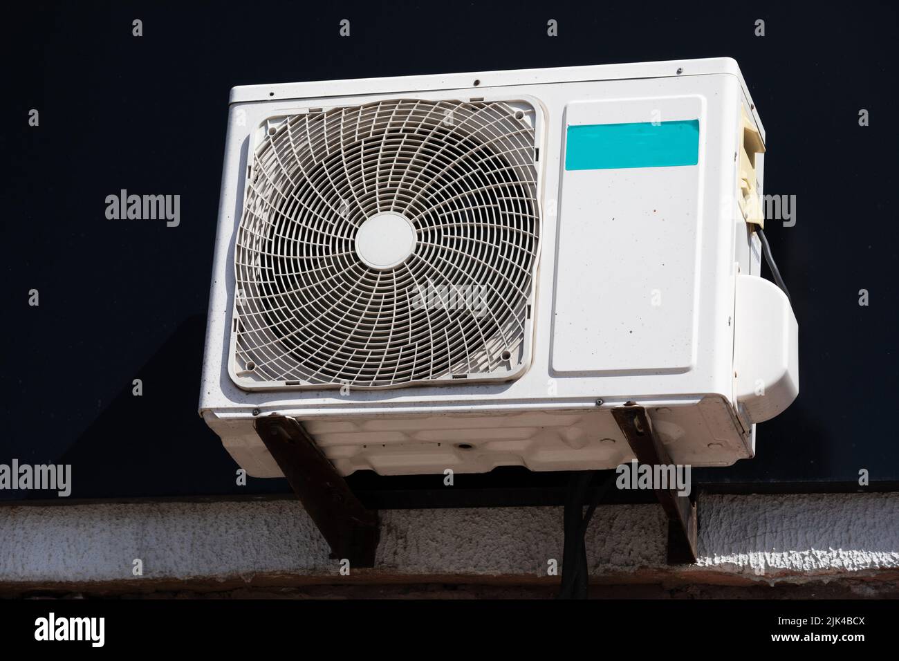 outdoor unit of a domestic air conditioner with a fan outside the