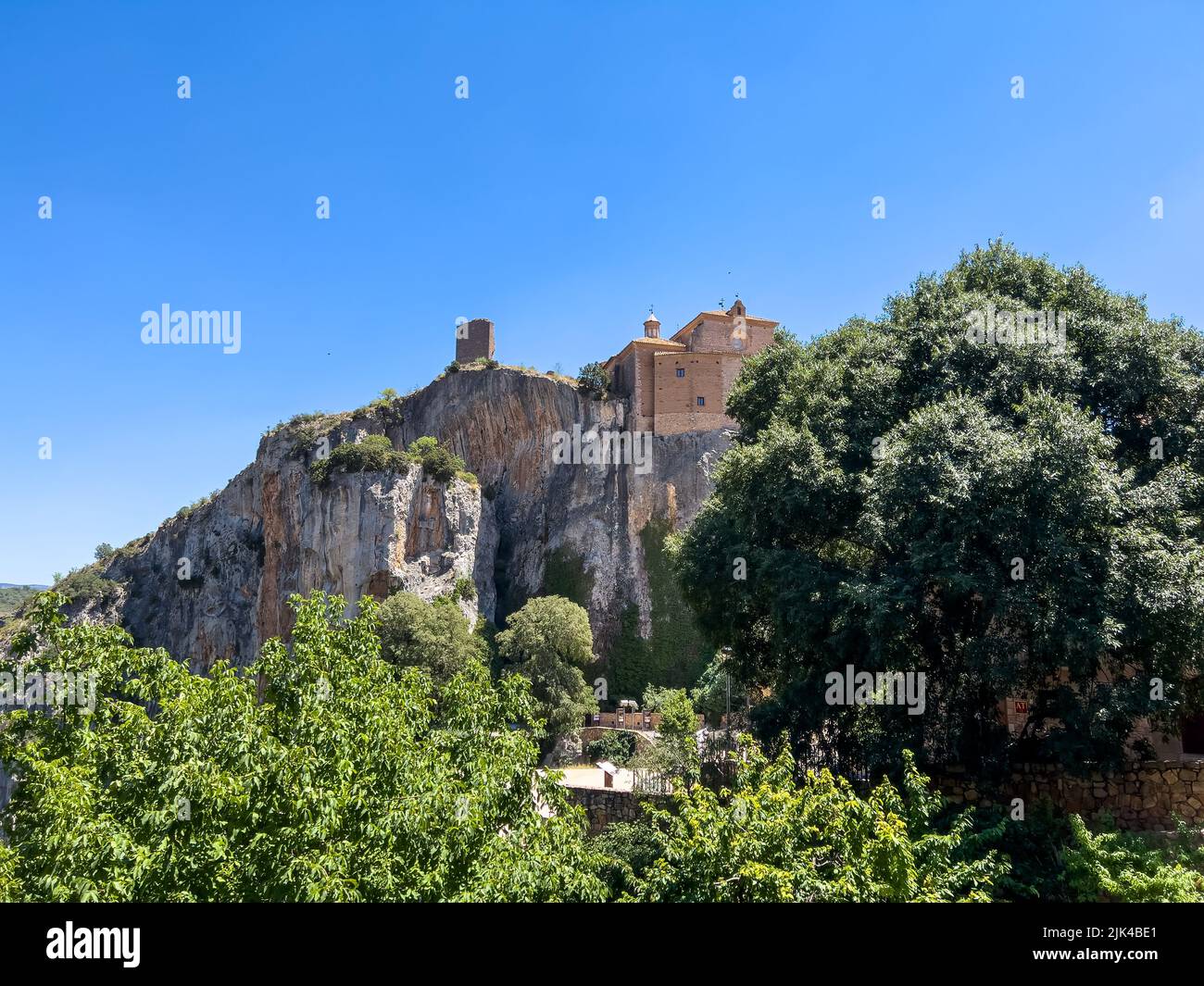 looking up at a religious building built on rock foundations Stock Photo