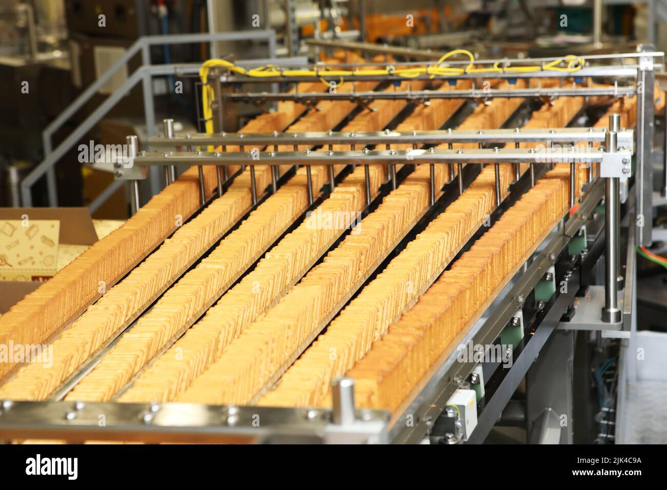 cookie making machine in the factory Stock Photo by Lobachad