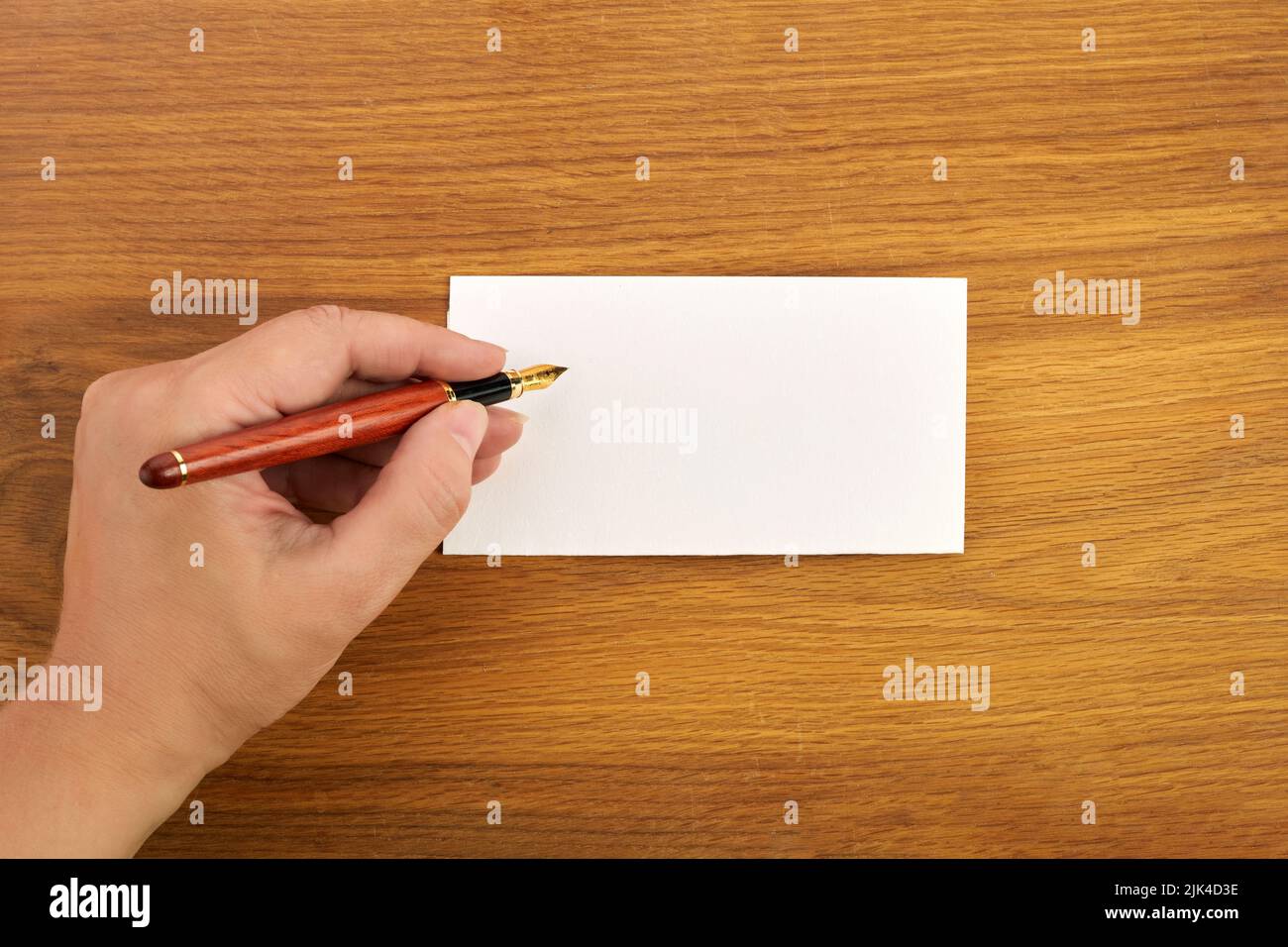 Woman writing by left hand. Left hander day concept. Stock Photo