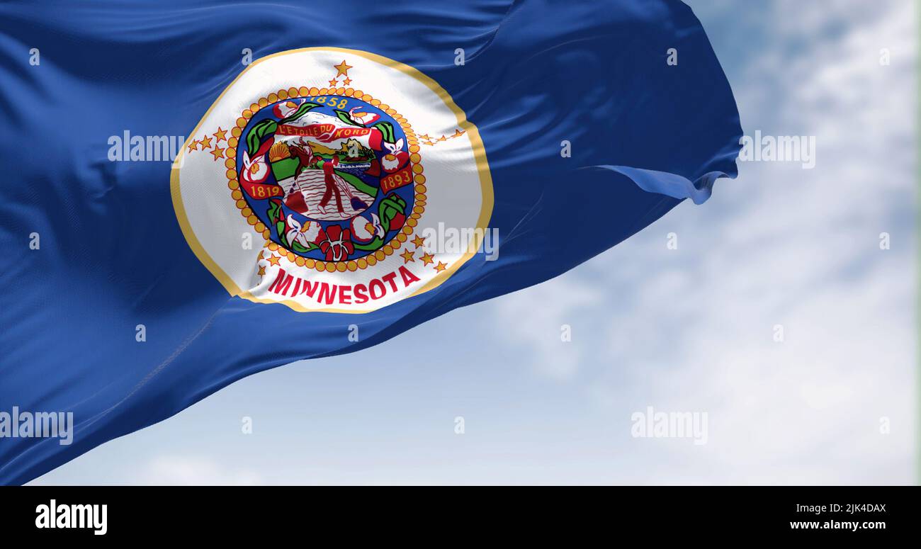 The US state flag of Minnesota waving in the wind. Minnesota is a state in the upper Midwestern United States. Democracy and independence. Stock Photo