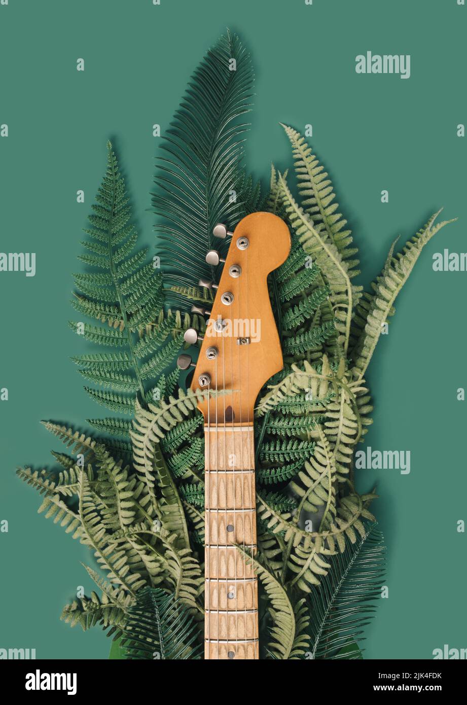 Worn electric guitar maple neck with foliage background. Nature sounds concept. Stock Photo