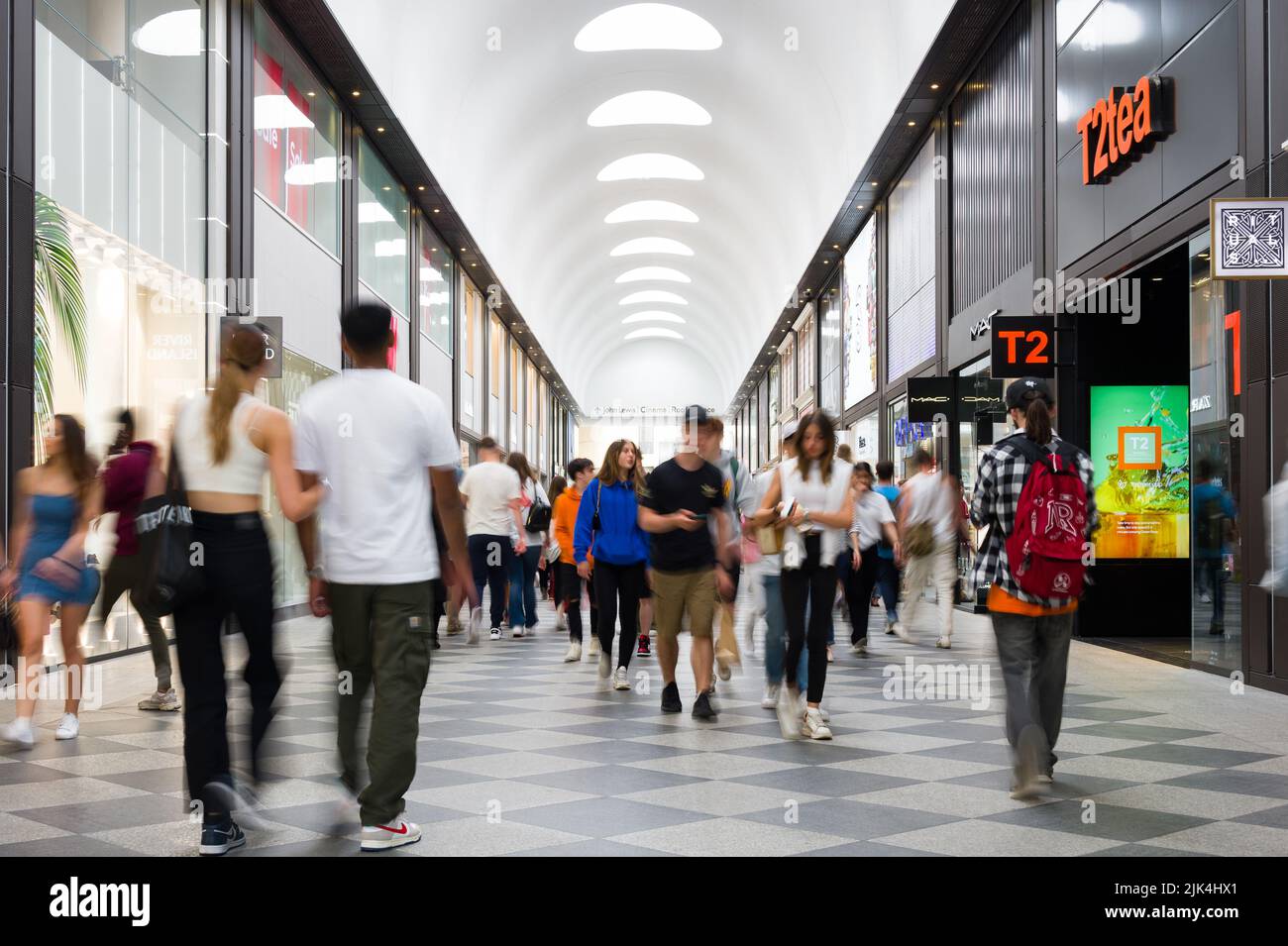 Interior of Westgate Shopping Centre with people walking past retail shops, Oxford, UK Stock Photo