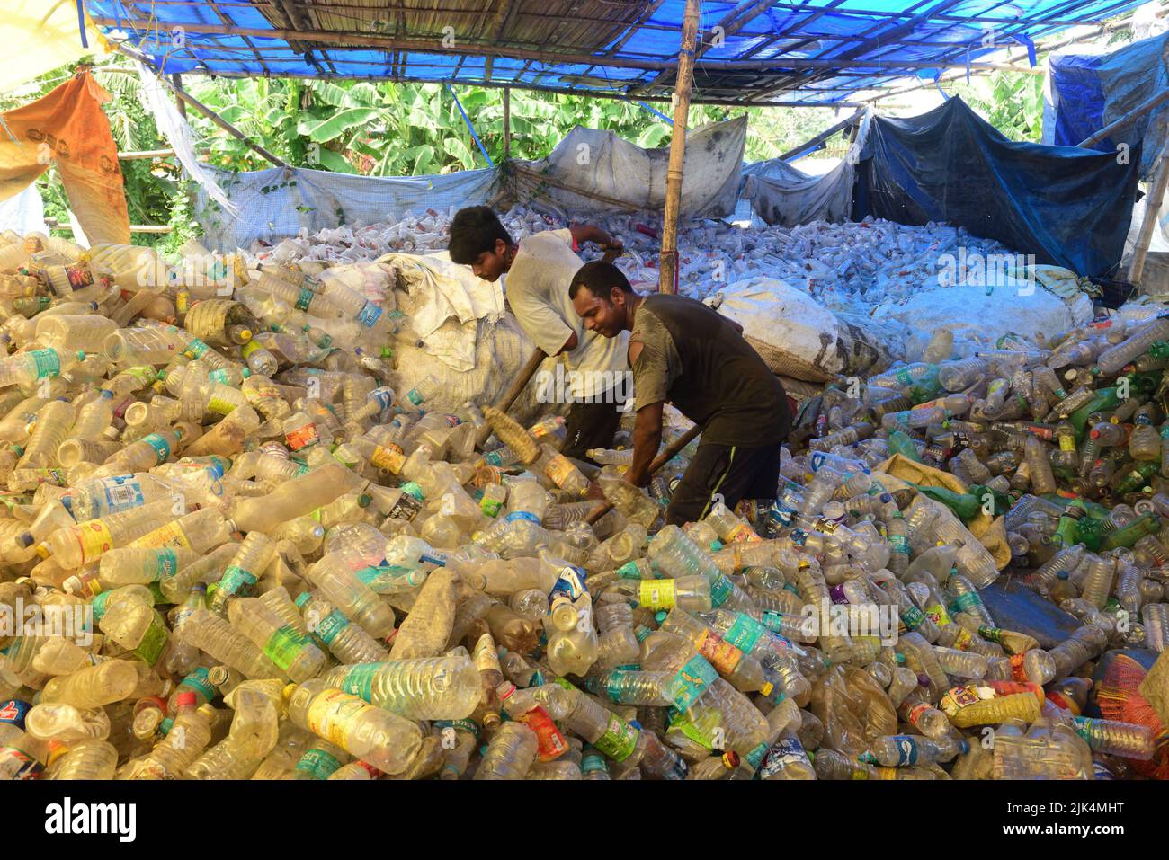 Workers seen sorting plastic bottles at a workshop before sending them for recycling. Plastic bottles are recycled and turned into polyester which is used in garments and jerseys all over the world. Many countries have started to ban single use plastics to tackle the environmental issues. Stock Photo