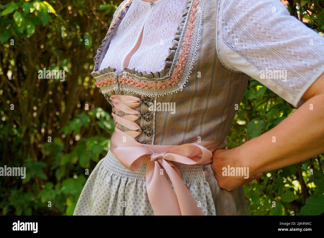 a woman in a beautiful traditional Bavarian dirndl dress (or Tracht) at the Bavarian October fest (Oktoberfest) (Munich, Bavaria, Germany) Stock Photo