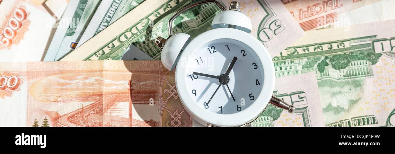 Time value of money concept, analog clock on US dollar banknote ...
