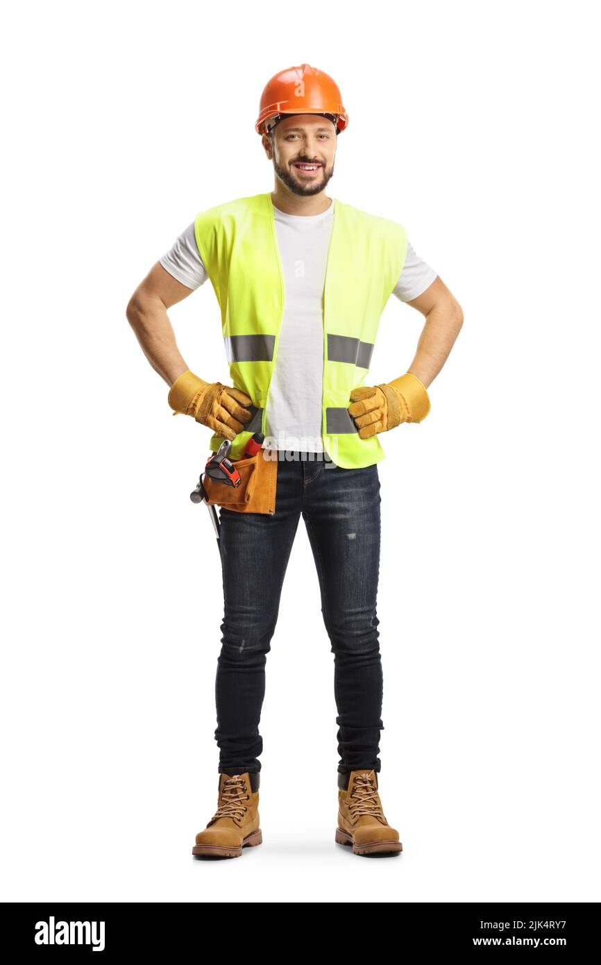 Full length portrait of a site engineer wearing a tool belt and smiling ...